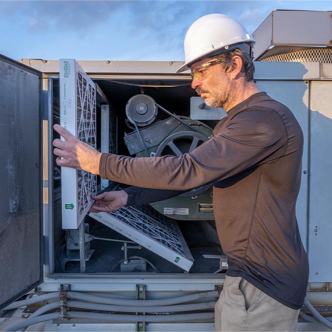 man working on an AC unit