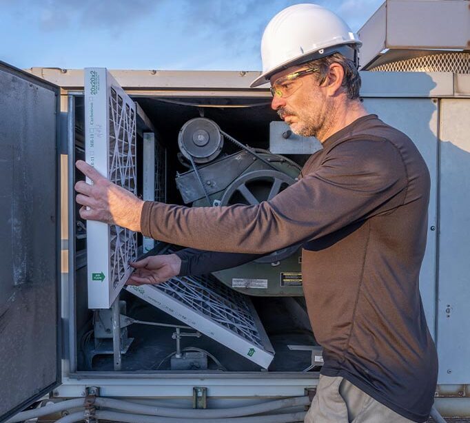 person working on an hvac unit